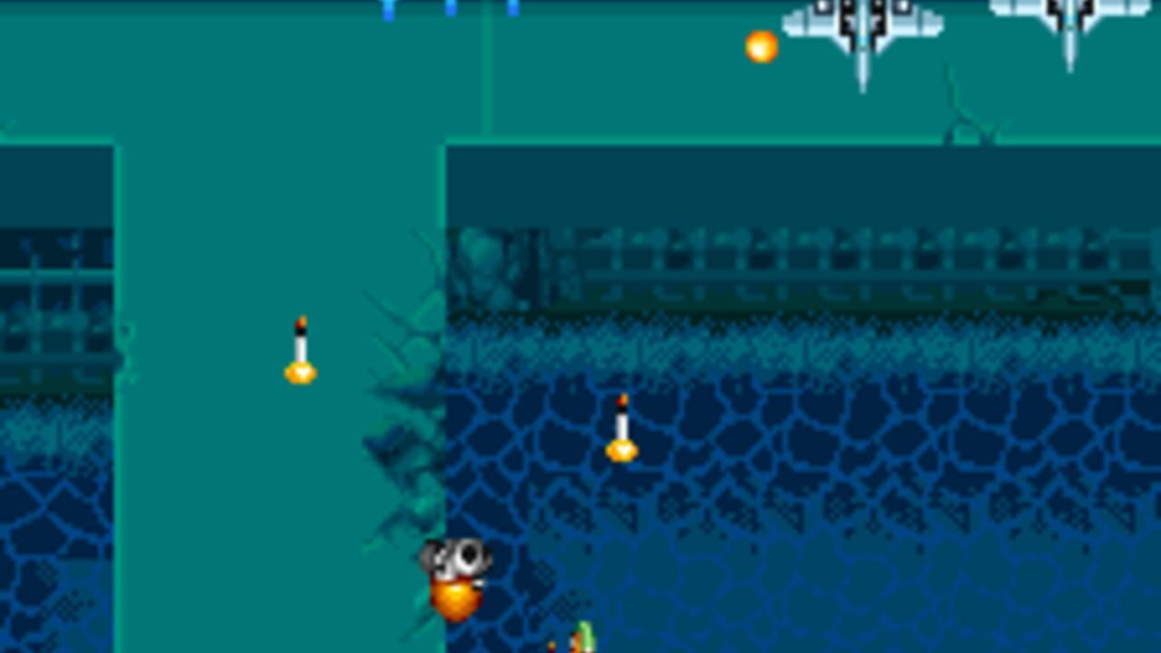 A vertical scrolling shooter displays a teal and blue underwater environment with a segmented floor pattern. Three small yellow spherical projectiles float at different heights in the center-left area. The player's ship, a compact orange and white vessel, occupies the lower-left portion of the screen. Enemy formations appear at the top and along the right edge, rendered as white geometric patterns against the darker background. A large alien structure with vertical spikes extends across the upper-right corner.