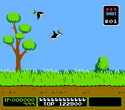 A bright blue sky forms the background above a green grass and brown dirt ground. On the left side stands a tall tree with a brown trunk and rounded green foliage. Two black ducks fly in the upper portion of the screen. On the right, a smaller green shrub sits on the grass. The game's UI appears at the bottom with a black status bar displaying score 'IP:000000' on the left, ammunition count in the center showing white pellets, and a black section on the right. A small red score indicator reads 'B O 1' in the upper right corner of the play area.