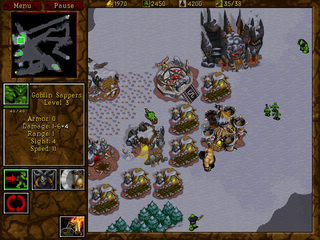 A top-down isometric view of a medieval fantasy battlefield displays multiple gold-roofed buildings and wooden structures scattered across a light gray-tiled terrain. Green-armored infantry units and cavalry are positioned throughout the map, with concentrated unit groupings in the center and lower portions. The left side shows a brown-paneled UI with a minimap in the upper left, unit portraits and command icons below, and a menu bar at the very top. Dark gray mountains or terrain borders appear in the lower right corner. The sprite-based graphics use limited color palettes typical of mid-1990s real-time strategy games.
