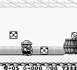 A Game Boy screenshot displays a side-scrolling platformer level with Wario as a small sprite centered in the frame, standing on a gray brick platform. To the left and right, similar brick platforms extend horizontally. Above the playfield, a row of wavy lines represents water or terrain. Two coin icons with X symbols appear in the upper area. The bottom UI shows a score counter displaying "8=05 0=000 '000 '333" in monospace font. The pixel art uses a monochrome green-tinted Game Boy color palette typical of the handheld's hardware.