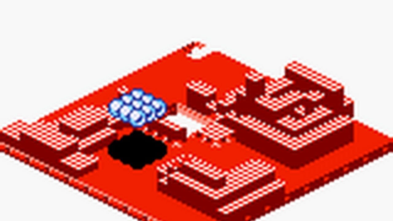 An isometric red platform with a black water droplet-shaped hole in the center. A blue cloud icon floats above the left side of the platform. Dark red cubic structures and raised sections form maze-like walls arranged around the playing field. The environment uses a bright red color palette with checkerboard-textured surfaces typical of Game Boy Color graphics. The perspective is tilted at an isometric angle against a light gray background.