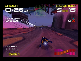 A futuristic racing craft hovers above a reddish-brown desert terrain with large cylindrical obstacles scattered throughout the landscape. The heads-up display shows lap time at 0:26.2 in the upper left, position 5 of 15 in the upper right, and lap timing data in the lower left corner. A purple-tinted mountain or rock formation rises prominently in the mid-ground. The color palette features warm reds and purples with geometric UI elements, typical of the N64's polygon-based 3D rendering. A pink sound wave visualization bar appears at the bottom center of the screen.