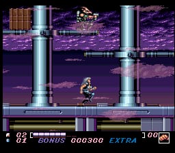 A sprite-based character stands on a purple platform in the center-lower portion of the screen, flanked by two tall cylindrical metallic structures. The background features a purple pixelated landscape with horizontal parallax scrolling visible at multiple depths. A horizontal green platform runs across the mid-section. The UI displays at the bottom shows score "000300", the word "BONUS", and "EXTRA" text with a health or power indicator showing "100" in the lower-right corner. The overall visual style uses a purple and metallic color palette typical of early 1990s SNES graphics.