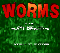 The Worms title screen features the word 'WORMS' in large red pixelated letters against a dark green background with a pixelated grass texture. Below the title, white text reads 'WORMS' followed by copyright and developer information attributing the work to Team 17 Software Ltd and licensed by Nintendo. The sprite-based graphics use a limited color palette typical of SNES-era games.