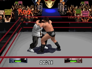 Two wrestlers grapple in the center of a red ring during a match. The left wrestler wears gray while the right wears black. A large blue face illuminates the crowd above, flanked by red neon signage. Health bars for both fighters appear at the top in green and red, with a match timer reading 00:41:6 in the center. The arena features pixel-art crowd sprites and geometric polygon models typical of N64-era graphics, rendered in dark tones with red accent lighting.