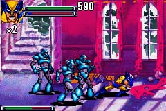 A purple-tinted urban street scene displays a group of X-Men characters standing in formation on a sidewalk in front of a magenta building with ornate windows. The health bar reads 590 at the top left. The sprite-based characters are rendered in a low-resolution pixel art style typical of GBA games, with blue and yellow costume accents visible. The background features parallax layering with purple architectural elements and darker shadows suggesting an indoor or sheltered location. The UI includes a health bar at the top and what appears to be a status panel at the bottom of the screen.