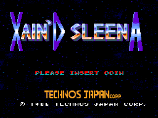 The title screen displays 'XAIN'D SLEENA' in large purple and cyan letters against a black starfield background. Below the title, yellow text reads 'PLEASE INSERT COIN'. At the bottom, orange text states 'TECHNOS JAPAN CORP.' with a copyright notice for 1988 Technos Japan Corp. The overall design uses a limited color palette typical of mid-1980s arcade hardware, with pixelated lettering and a dark space-themed aesthetic.