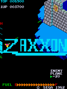 The title screen displays "ZAXXON" in large cyan pixelated letters across the center, with an isometric 3D-rendered fortress structure in gray and blue above it. The top-left corner shows score information reading "TOP 003900" and "1UP 003700" in cyan text. The bottom-right displays "ENEMY PLANE" with a green indicator showing "20". A yellow fuel meter bar spans the lower portion with repeated yellow segments. The background is entirely black, and all graphics use the characteristic blocky pixel style of early 1980s arcade games. A copyright date "1982" appears in the bottom-right corner.