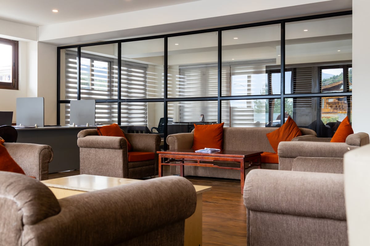 Reception lounge with warm orange accent pillows