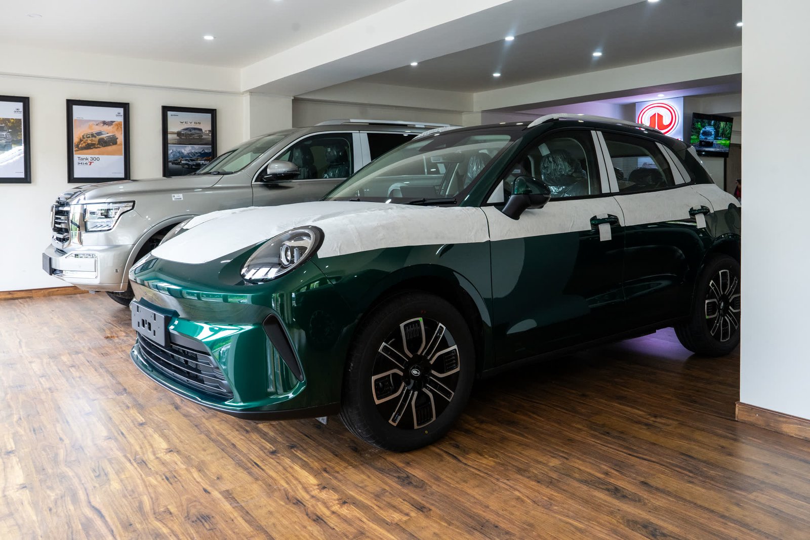 Factory-fresh ORA 5 in green beside a Tank 300 on the showroom floor