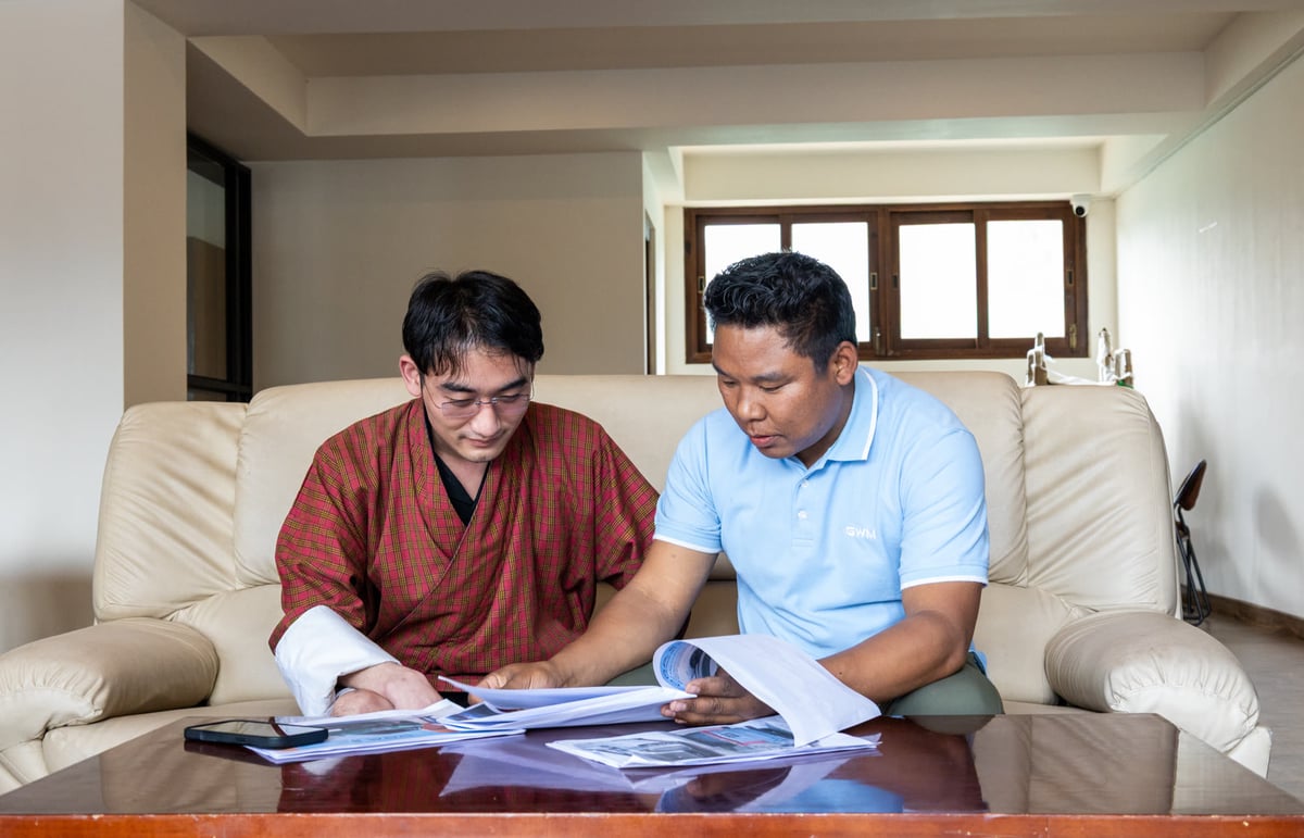 Team member reviewing a vehicle brochure with a customer