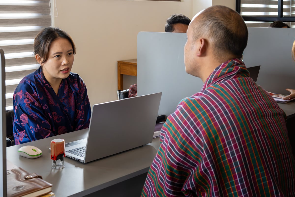 Team member walking a client through options on a laptop