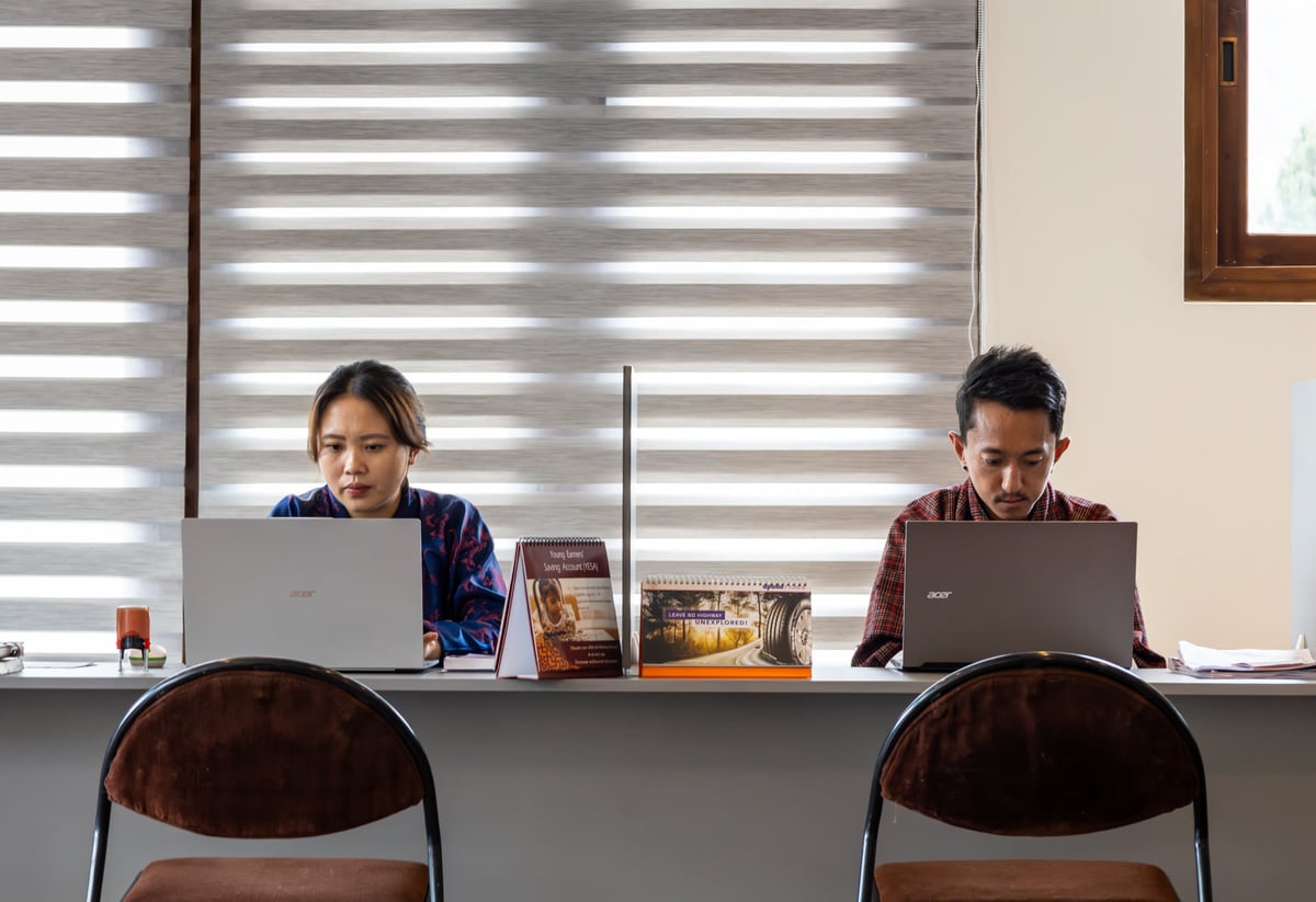 Two team members at their workstations