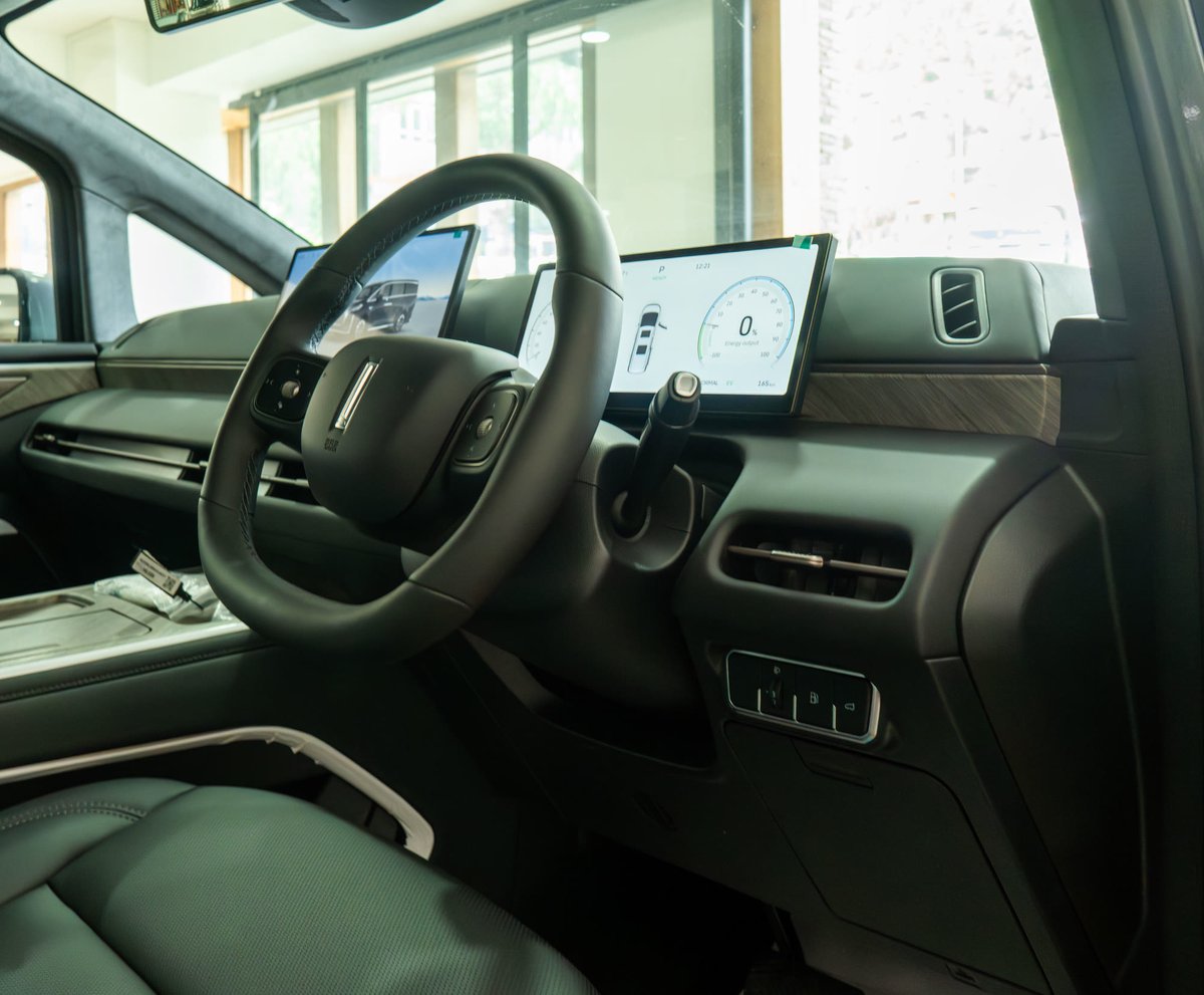 WEY G9 cockpit — steering wheel with the driver display and centre screen behind it