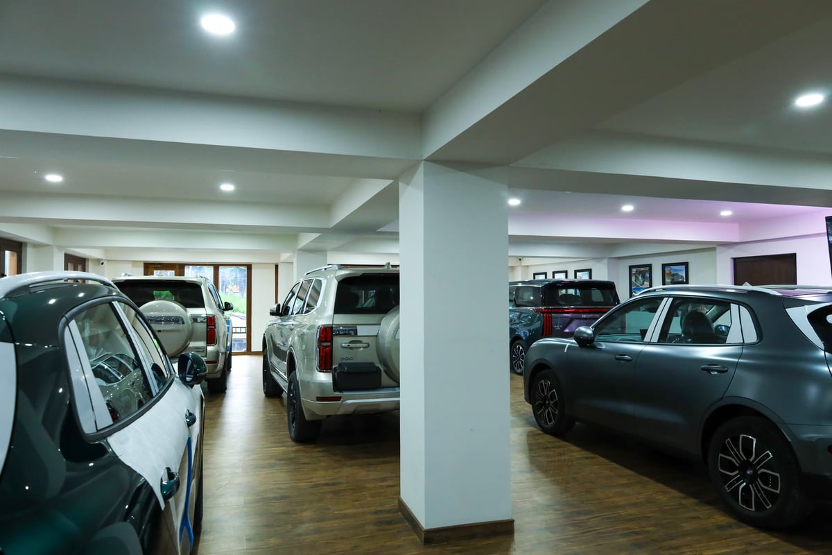 The showroom floor from the far end, GWM SUVs either side of a pillar
