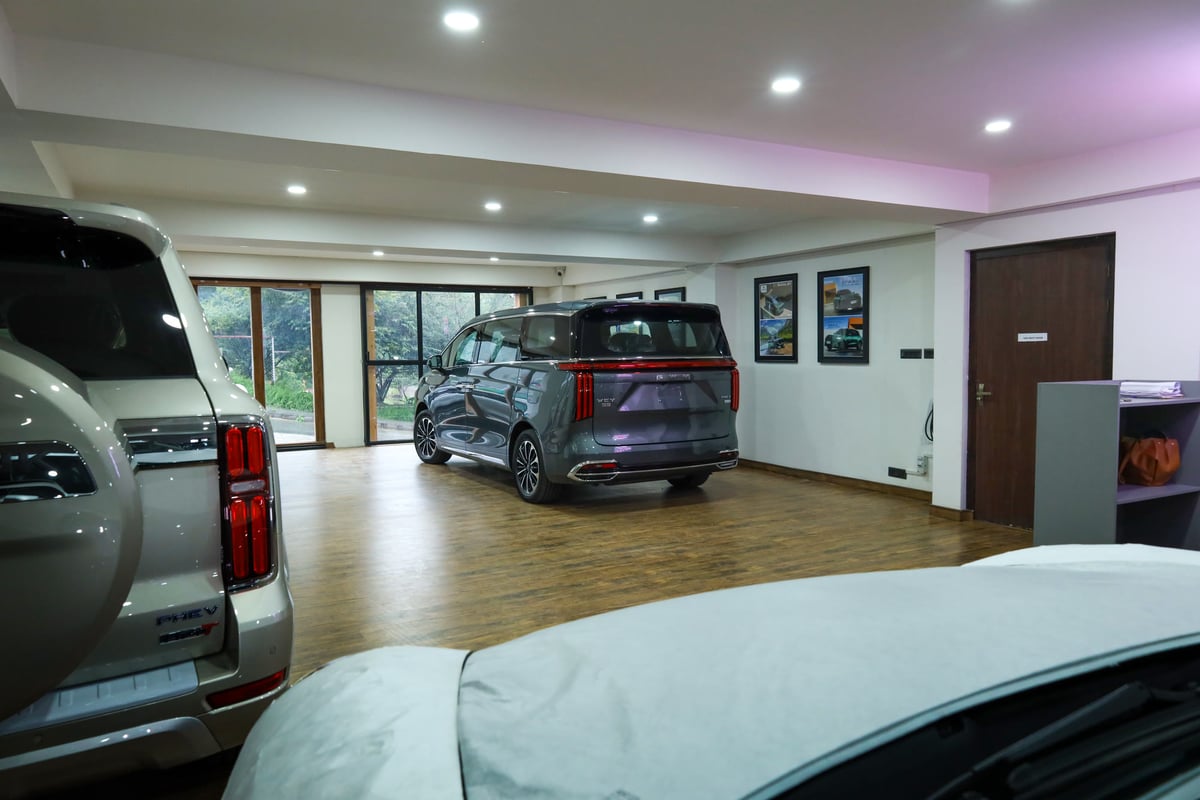 The showroom floor viewed from the entrance, vehicles parked on both sides