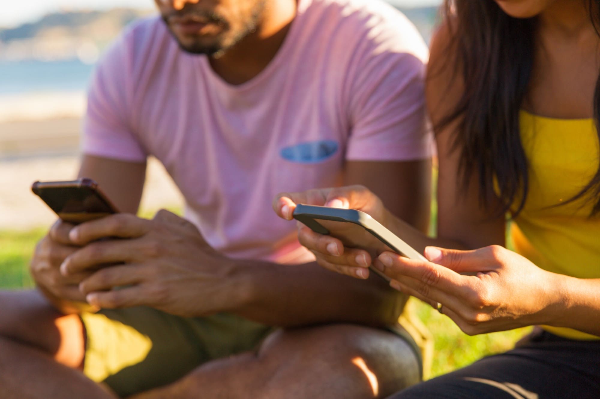 People using their mobile devices in the park