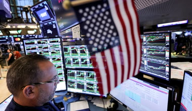 Traders work on the floor at the New York Stock Exchange (NYSE)