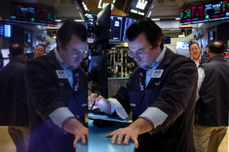 Traders work on the floor of the NYSE in New York