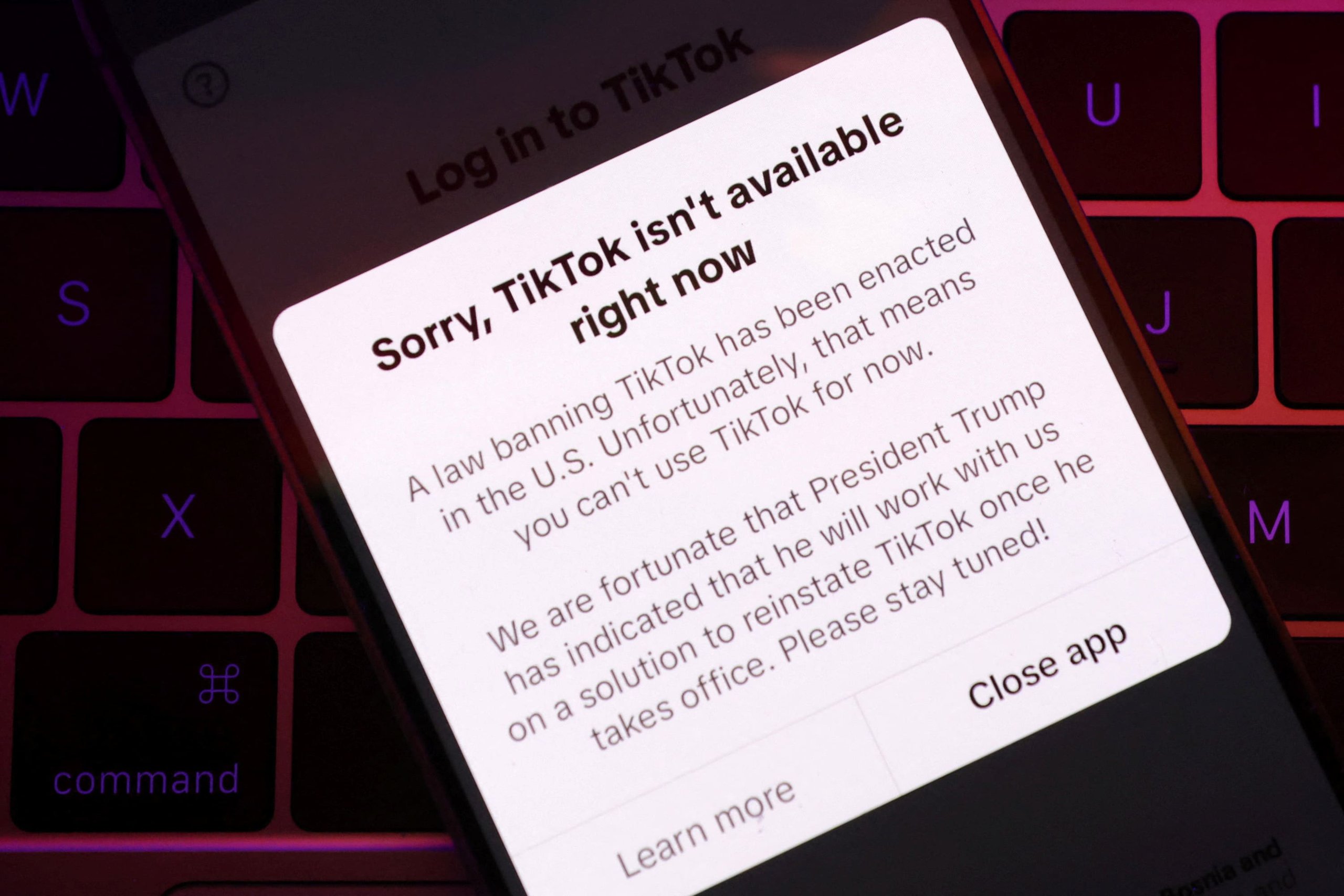 Illustration shows TikTok app with the message "Sorry, TikTok isn't available right now