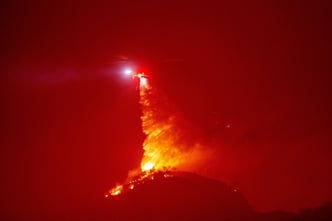 Firefighters and aircraft battle the Hughes Fire near Santa Clarita