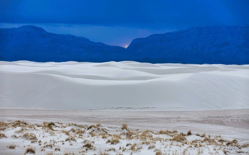 A picturesque view of White Sands National Monument set against the sky at sunset