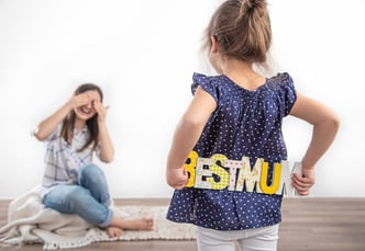 A sweet little girl celebrates her mother