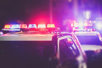 Police cruiser lights at a nighttime checkpoint