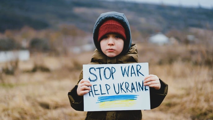 A sad boy pleads for an end to the war between Russia and Ukraine