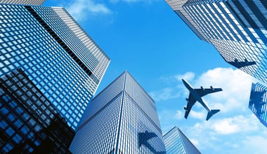 Airplane flying over building at Central Business District