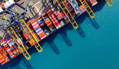 Bird's-eye view of a cargo ship and containers in the harbor