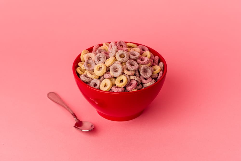 Bowl of cereal isolated on a pink background