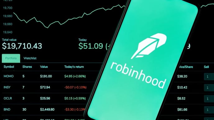 Robinhood Markets is an American broker-dealer company. A smartphone with the Robinhood logo on the background of the live trading webpage