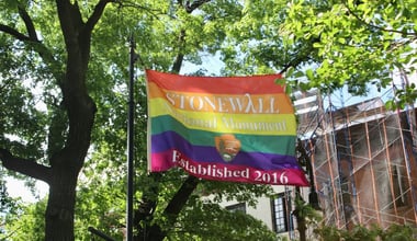 Stonewall National Monument Established 2016 rainbow flag from National Park Service flying in the park on Christopher Street in Greenwich Village, New York Cit