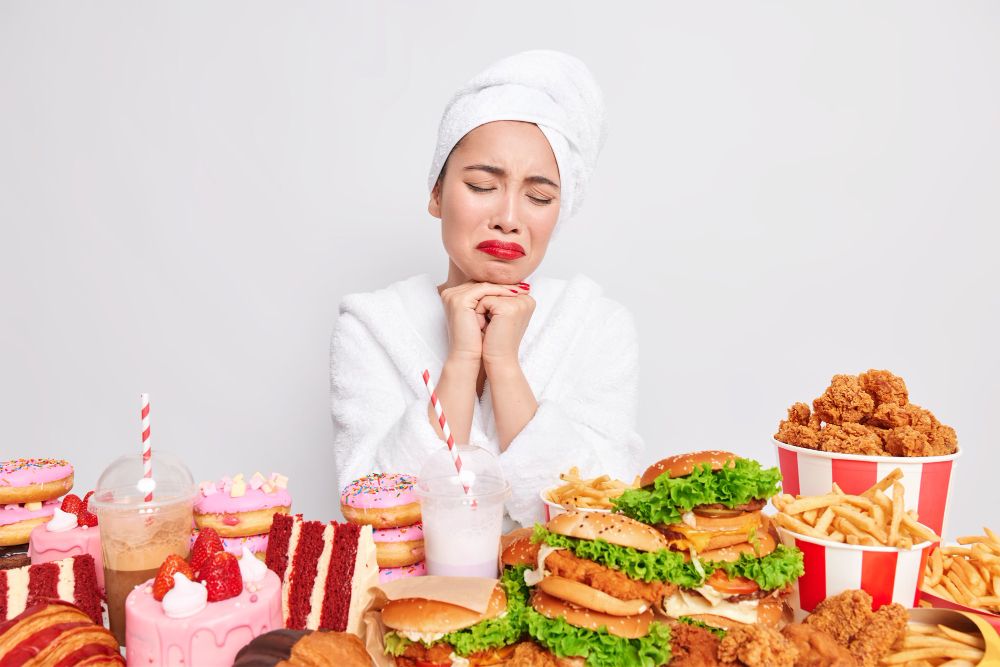 Stressed unhappy Asian lady wants to eat fast food