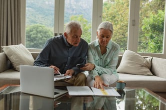 Energetic senior couple analyzing their investments