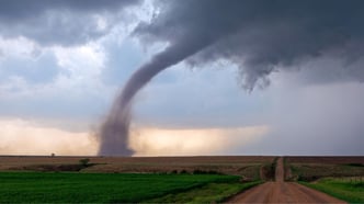 Tornado funnel spins beneath a supercell thunderstorm during a severe weather event