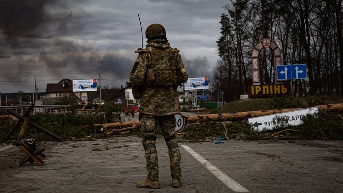 Ukrainian soldier stands on the check point to the city Irpin near Kyiv during the evacuation of local people under the shelling of the Russian troops