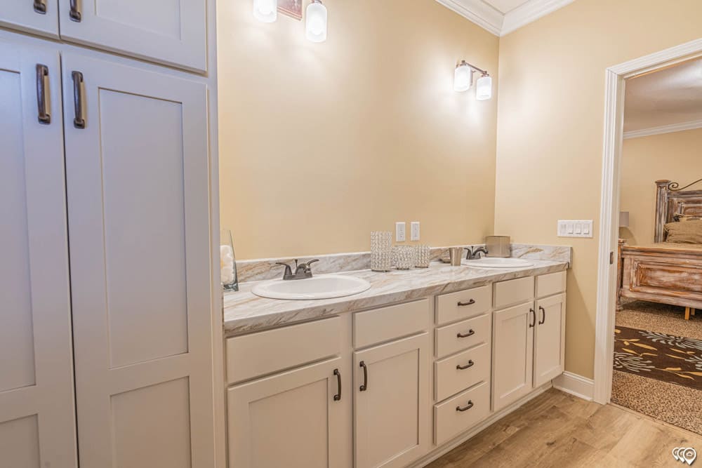 Primary bathroom double vanity with extensive storage in The Woodland