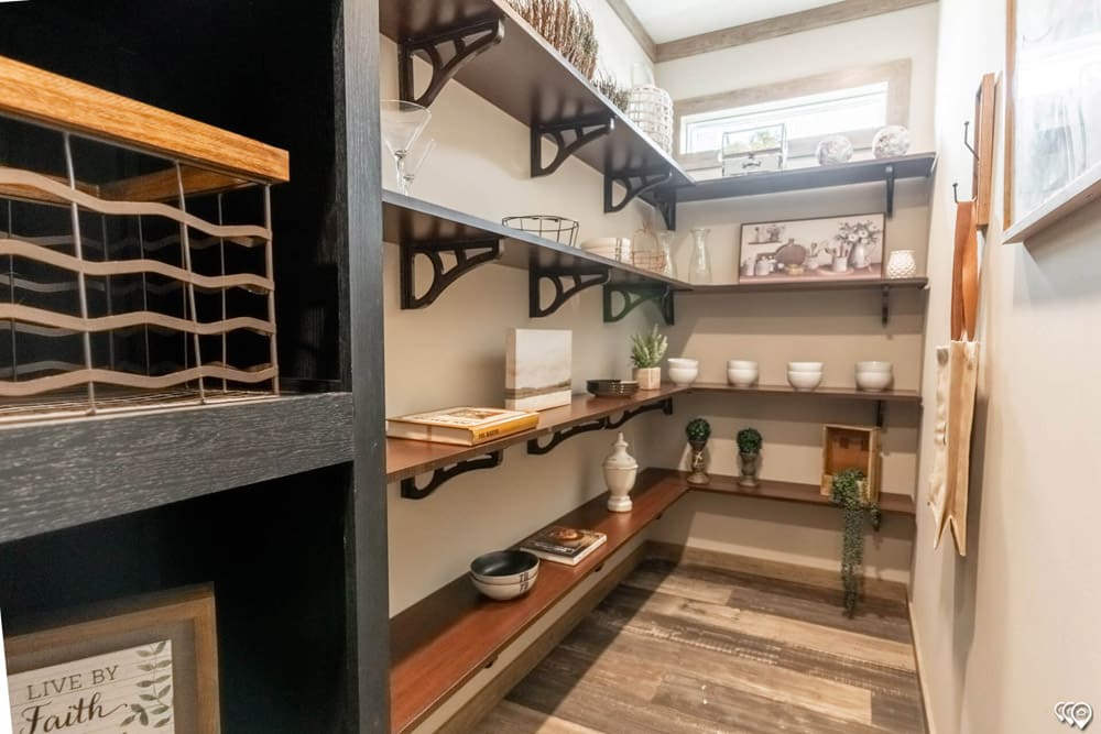 Walk-in pantry with extensive open shelving in The Shoal Creek
