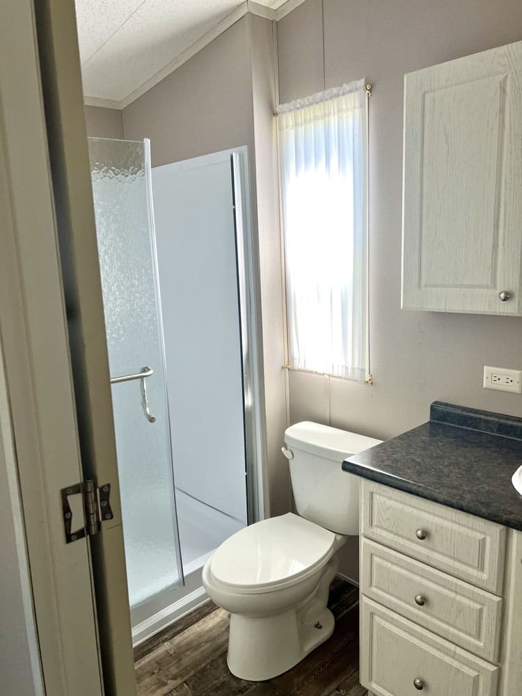 Full bathroom with shower and vanity in The Leah tiny home for sale in Conroe