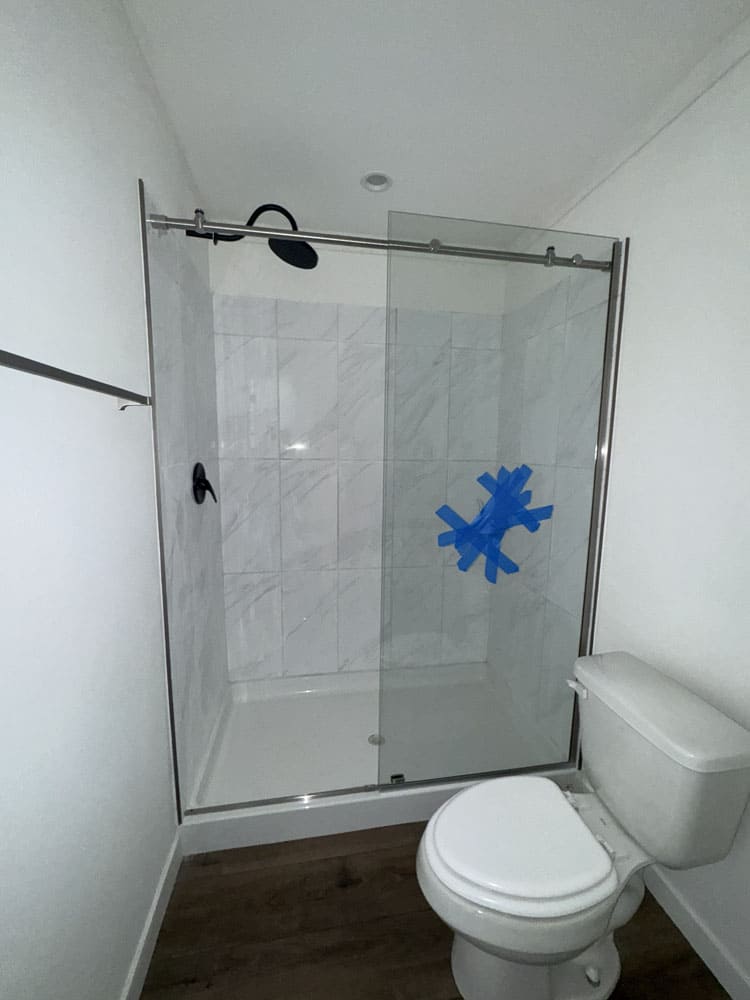 Bathroom with glass shower in The Cami Champion home for sale near Conroe