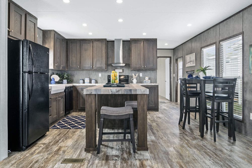Island kitchen and dining space in The Grant manufactured home