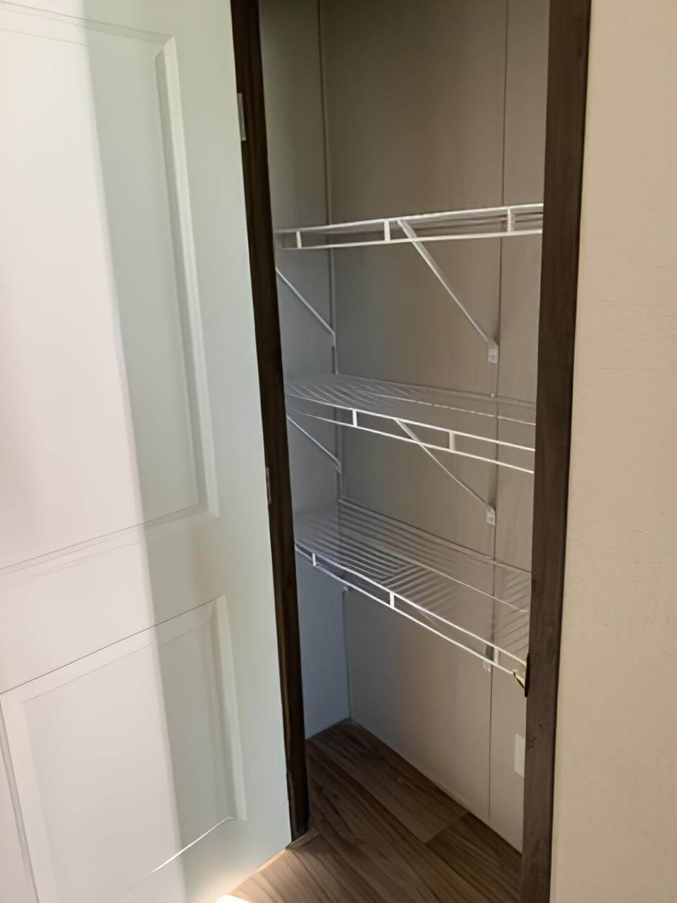 Walk-in pantry with wire shelving in The Spirit manufactured home