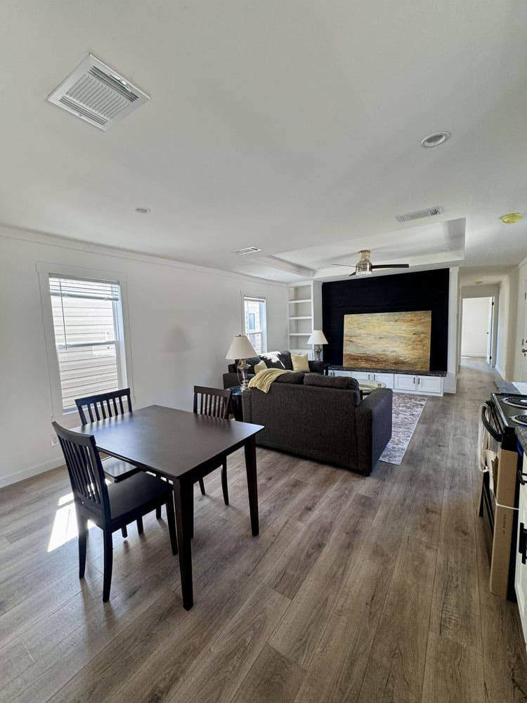 Open-concept dining and living space in The Cami Champion manufactured home