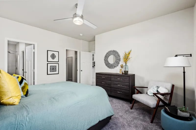 Primary bedroom suite in The Odyssey XL 3256 by Champion Homes