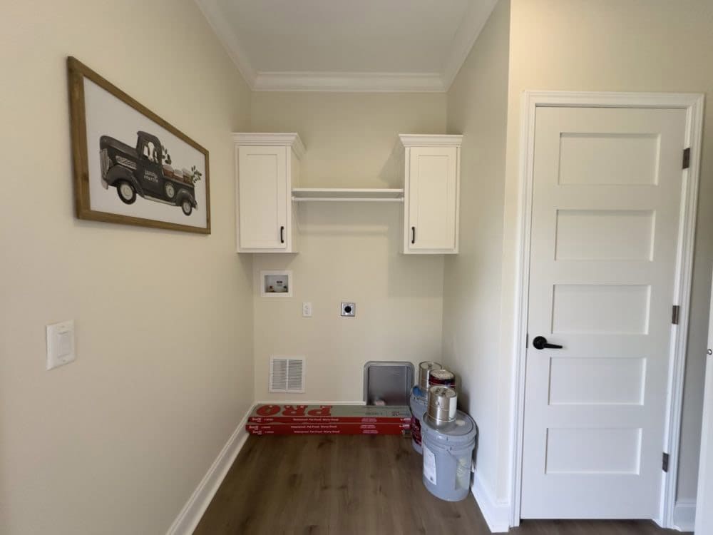 Laundry area with overhead cabinets in The Riverwalk manufactured home