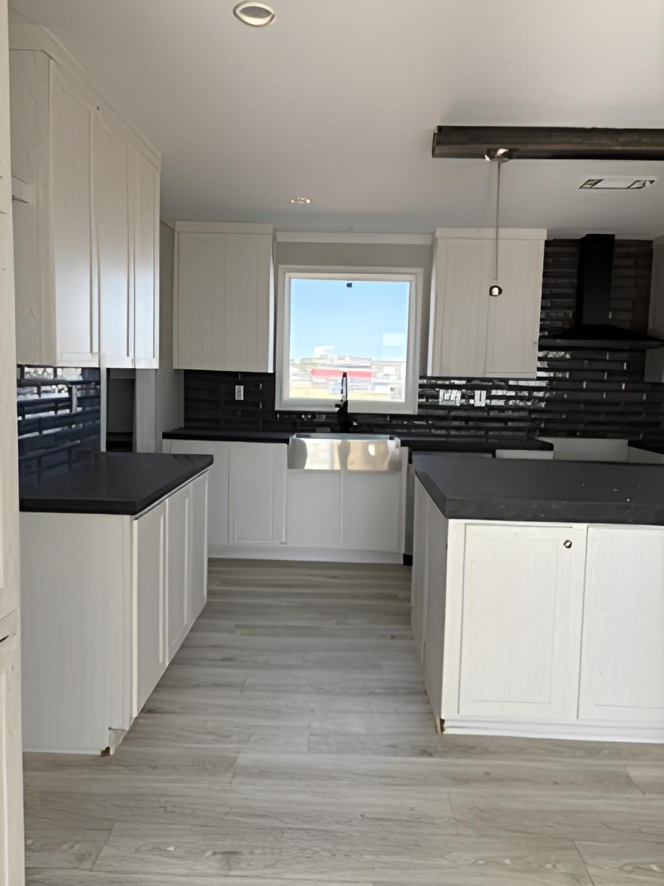White kitchen with black countertops in Midland TX doublewide home