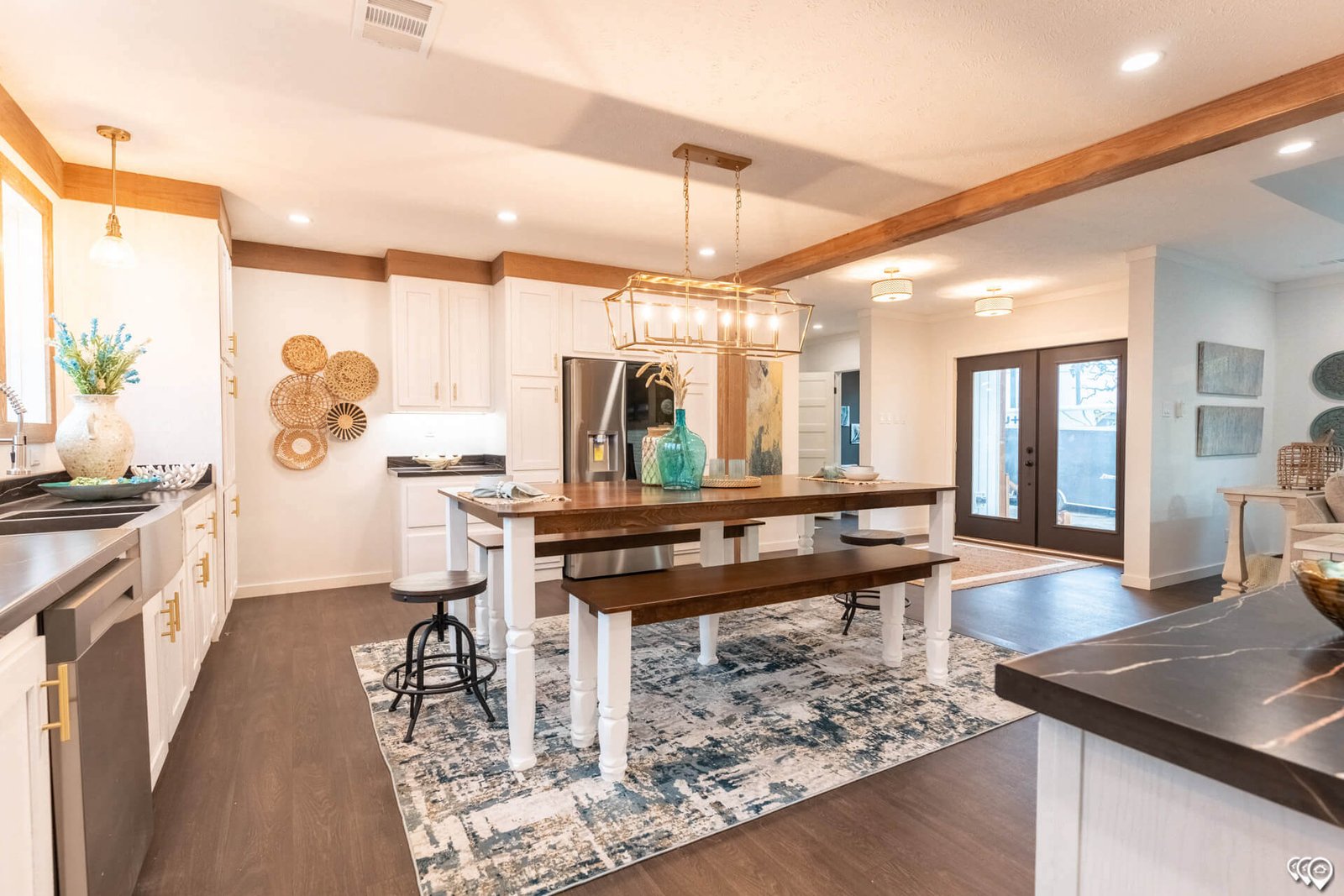 Open kitchen with dining island and wood accents in The Trinity CS-3242