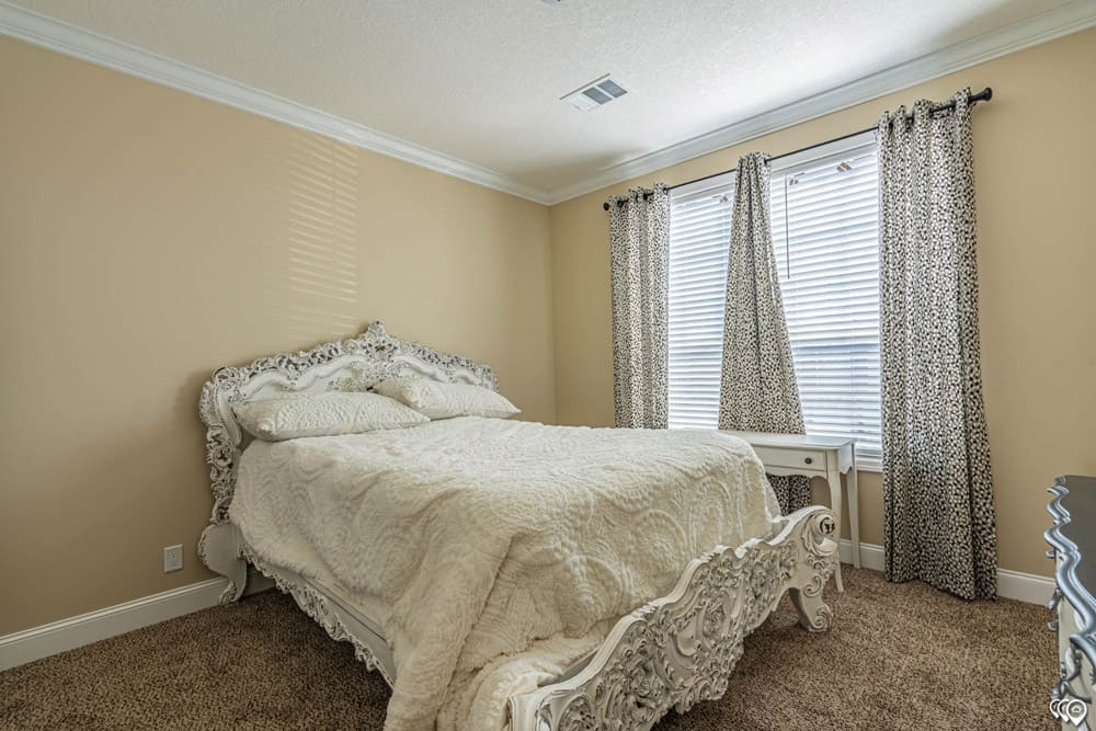 Furnished guest bedroom in The Woodland four-bedroom home